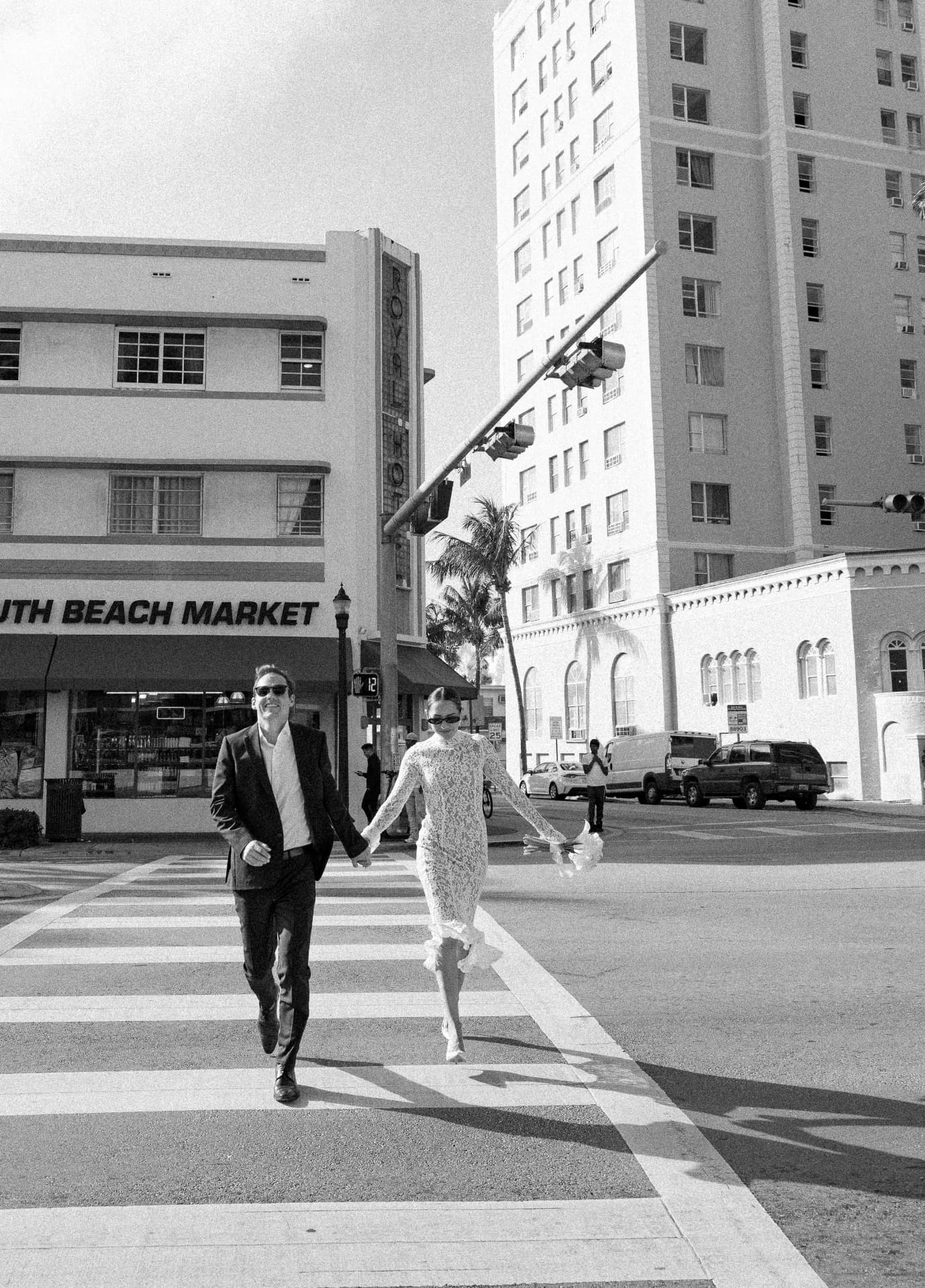 The couple crossing the street holding hands