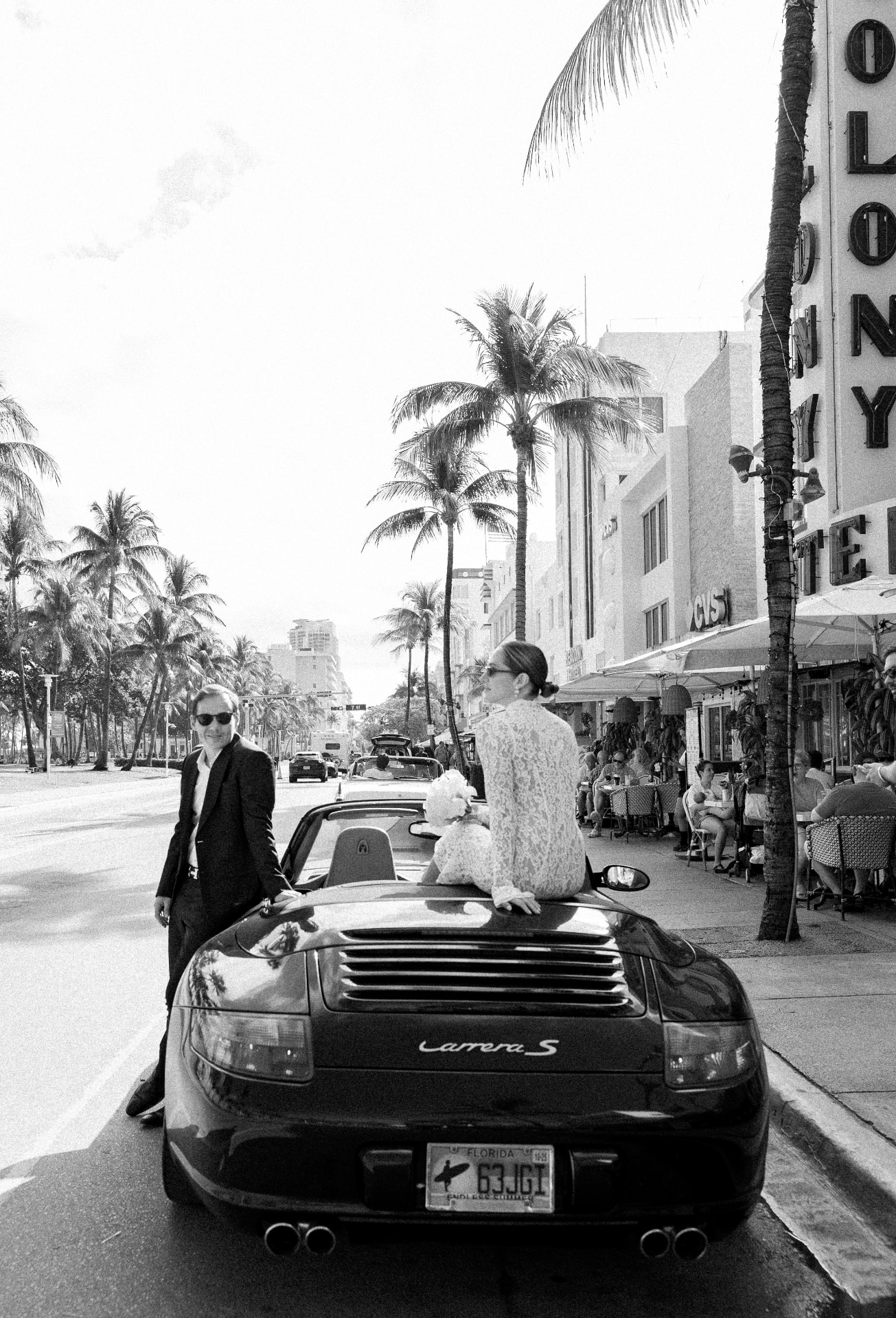 The couple on a palm-lined street